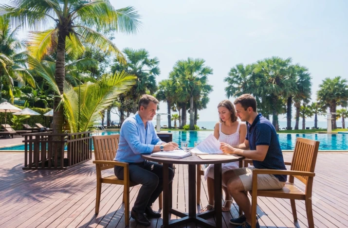 Couple working with a realtor to buy a Panama beachfront property